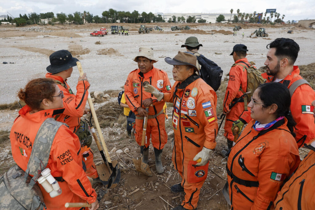 Un grupo de rescatistas mexicanos, de la Brigada Internacional de Rescate Topos Azteca, durante las tareas de búsqueda y rescate en la rambla del Poyo, una de las principales vías que recorrió el agua durante la riada, este jueves en Valencia