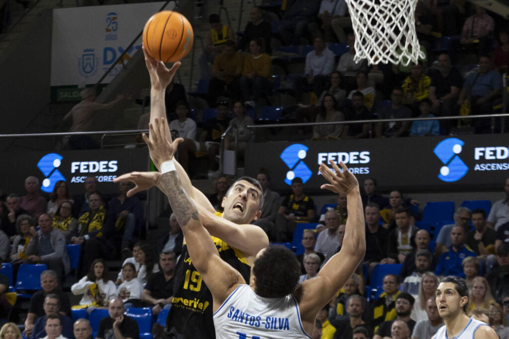 El pívot de La Laguna Tenerife Giorgi Shermadini (i) lanza a canasta ante Santos Silva, del Saint-Quentin Basket-Ball, durante el partido de la fase regular de la Liga de Campeones de Baloncesto (BCL) que enfrentó a ambos equipos este miércoles en el pabellón Santiago Martín en La Laguna (Tenerife). EFE